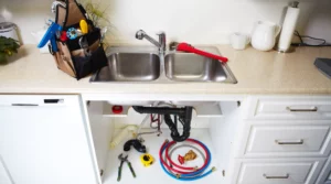 plumbing tools and bag of equipment on top of kitchen sink